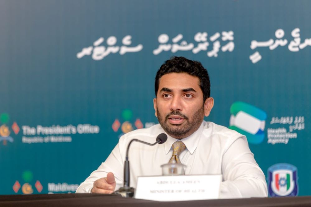 health minister speaking at press conference