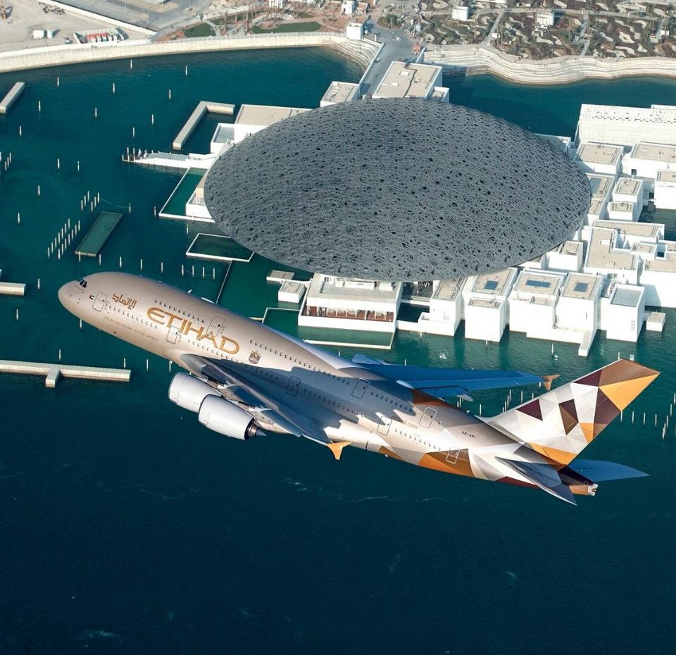 Etihad Airways Aircraft flying over the louvre museum in abu dhabi