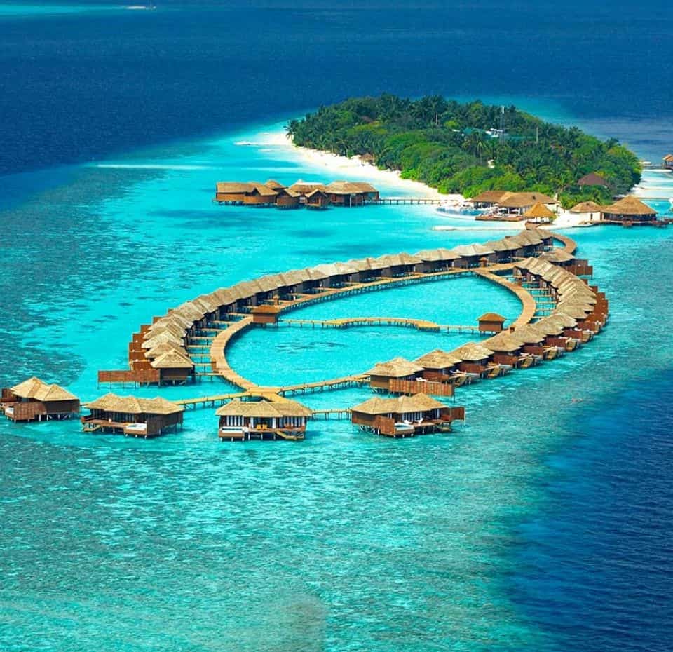 Lily hotels resort , an Arial view of the resort with shades of blue ocean and over water villas.