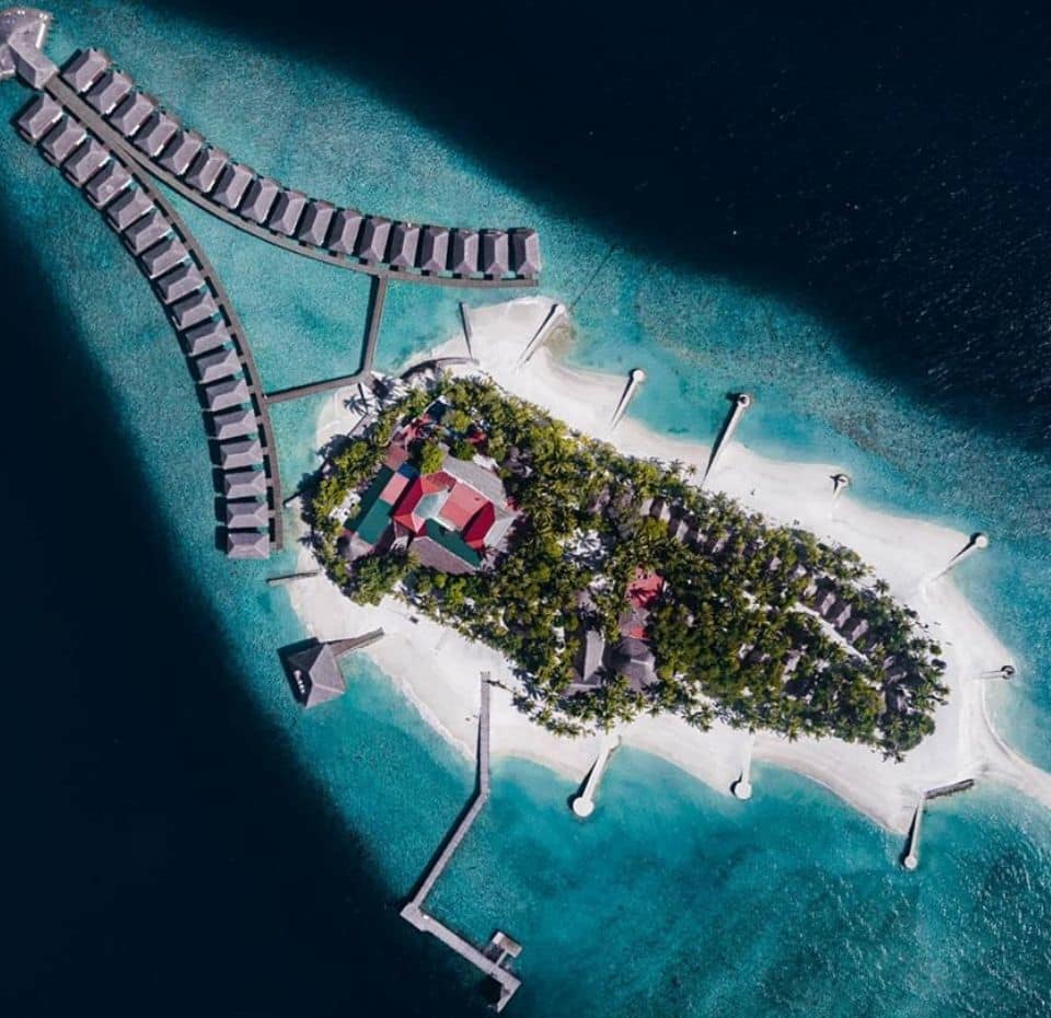Drone image of a maldivian resort with multiple shades of blue. Maldives nominated for Conde nest travelers awards