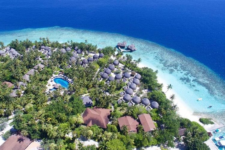 Arial view of Bandos Maldives with beach villas and multiple shades of blue.