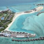 Cinnamon Dhonveli Maldives aerial view from a drone. Over waters villas and restaurants.