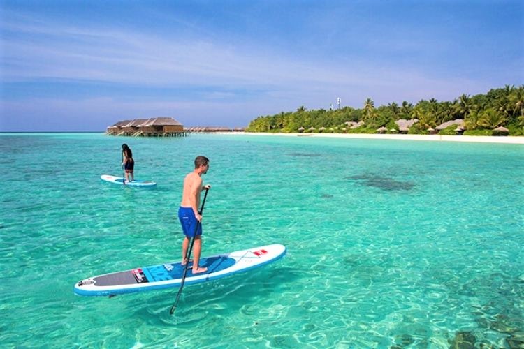 Guests enjoying the crystal clear waters of Maldives in Veligandu Maldives.