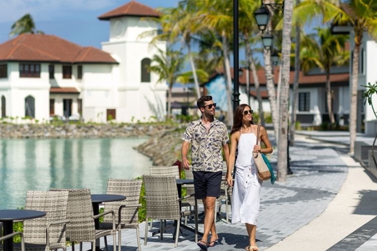 guests walking by the marina at crossroads maldives