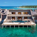 Vommuli resort's overwater villas surrounded by beautiful lagoon