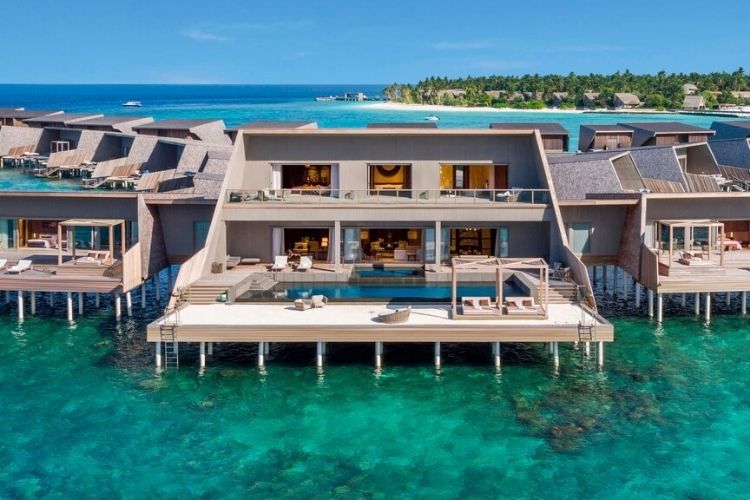 Vommuli resort's overwater villas surrounded by beautiful lagoon