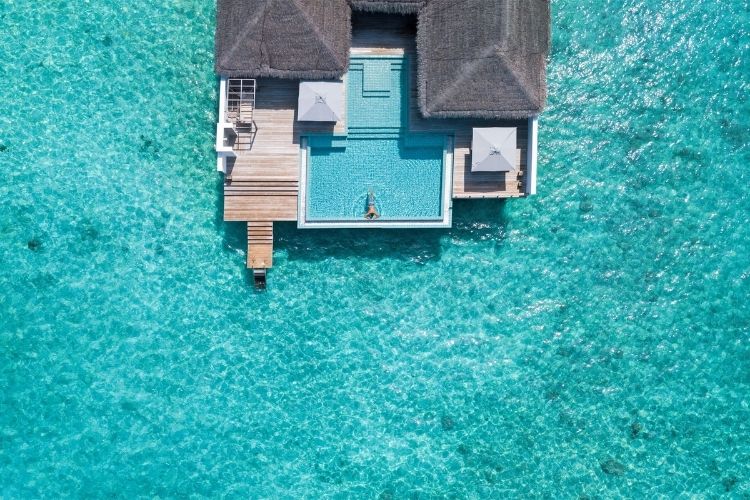 aerial of an overwater villa at seaside finolhu, Maldives