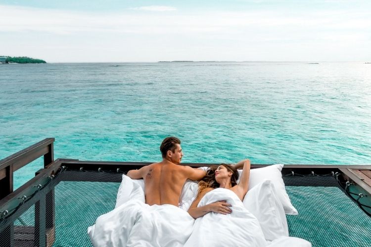 couple on the water suite outdoor deck at sheraton maldives