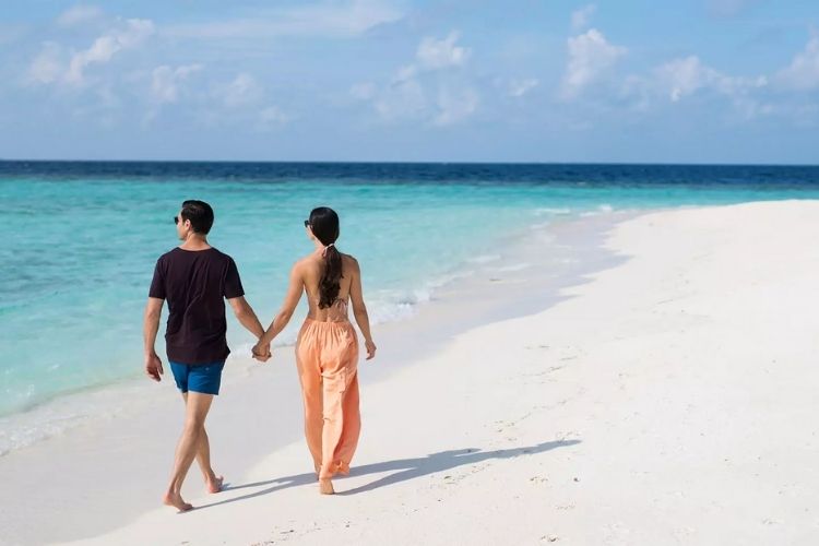 tourists enjoying holiday in a Maldives beach