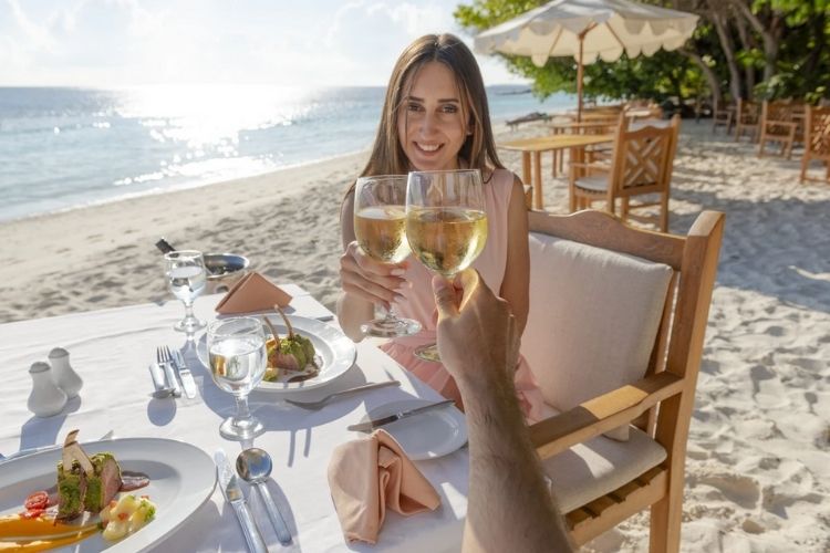 tourists enjoying holiday at maldives resort royal island