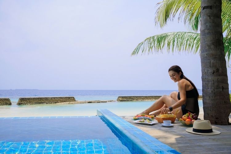 tourist near the pool at maldives resort
