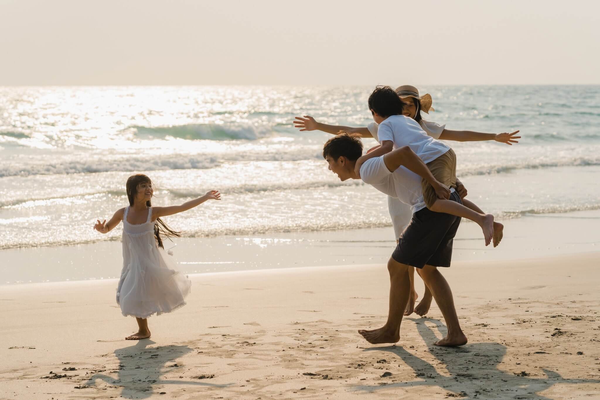 Travel Trends: Family on the beach at Dusit Thani